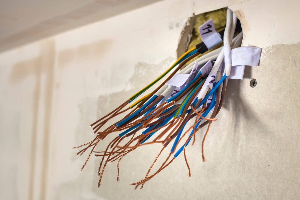 House wiring pulled from wall for rewiring upgrade.
