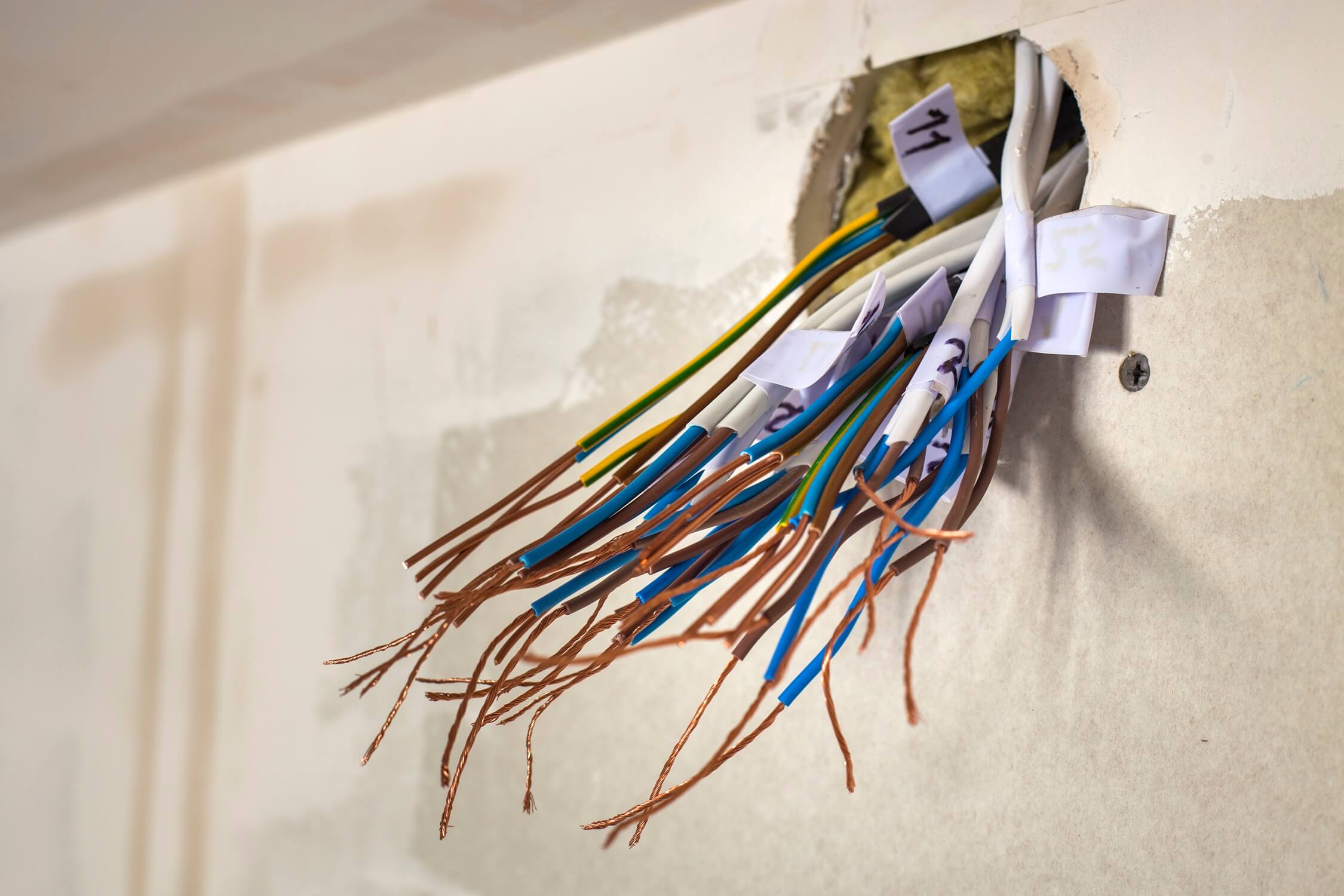 House wiring pulled from wall for rewiring upgrade.
